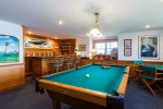 Downstairs game room with pool table and bar